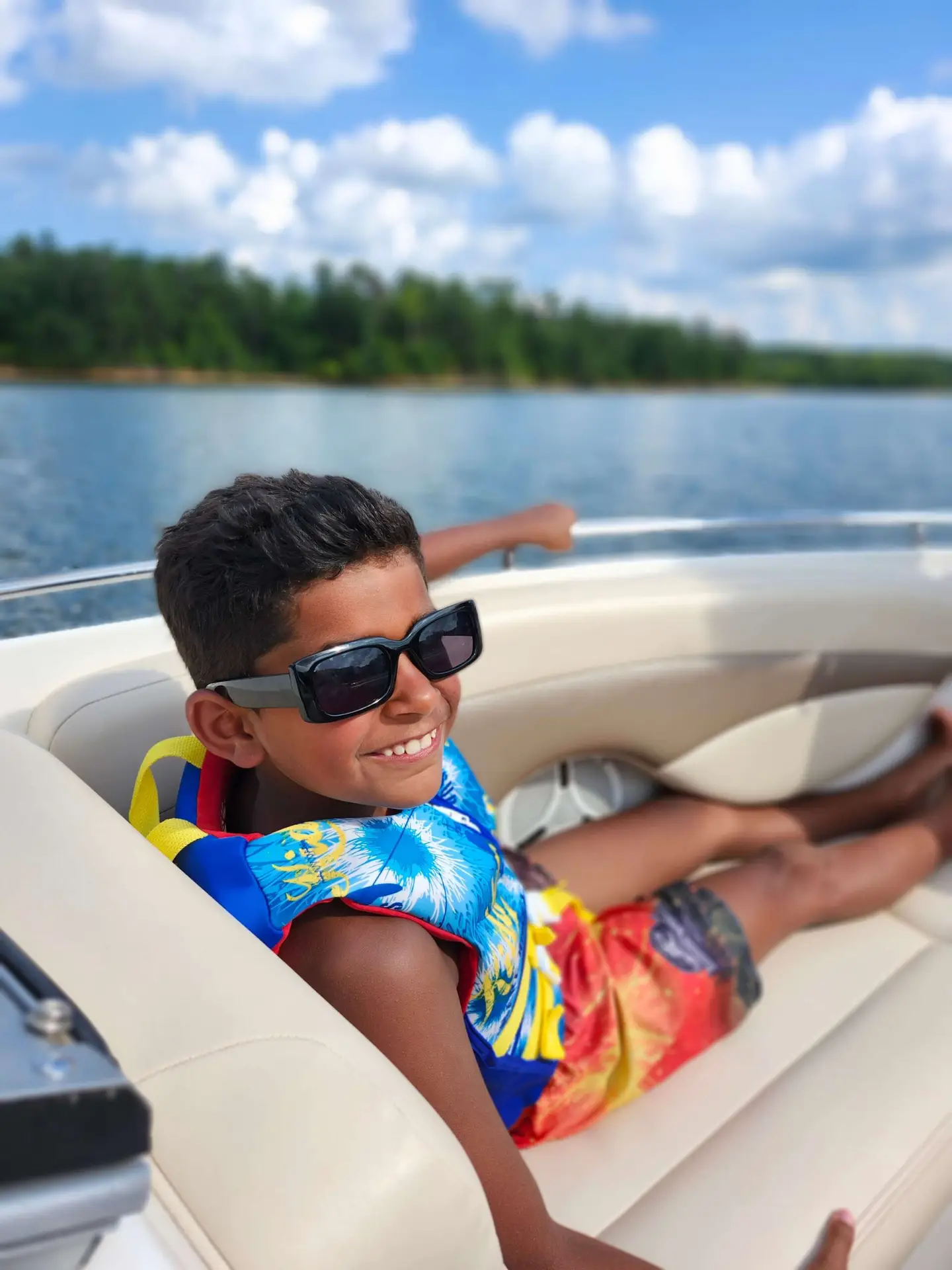 Pontoon boat and kayaks on Lake Thurmond during a summer afternoon